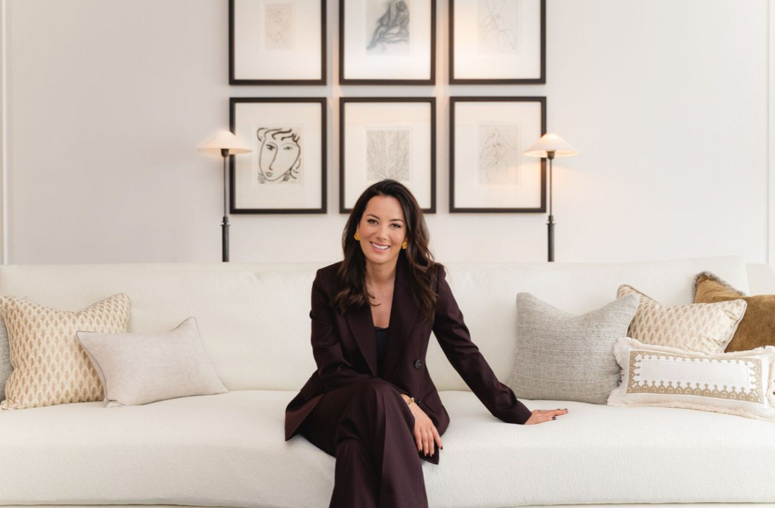 sophie paterson sitting on white couch smiling